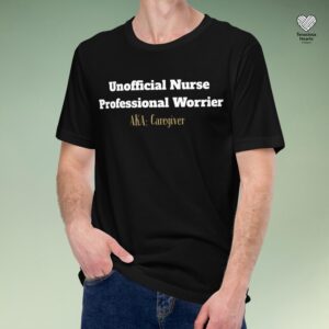 Black t-shirt on person against sage background featuring white text "Unofficial Nurse Professional Worrier" with gold "AKA: Caregiver" accent text