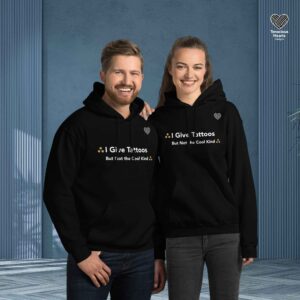 Two people wearing black hoodies against blue background with white text "I Give Tattoos But Not the Cool Kind" and small heart logo, representing radiation therapy professionals